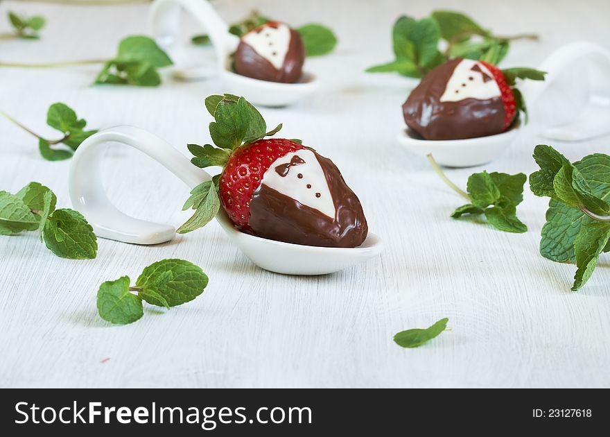 Strawberries in tuxedos made of dark and white chocolate. Strawberries in tuxedos made of dark and white chocolate