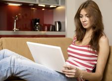 Young Woman Lying On A White Sofa With A Laptop. Stock Photos Young Woman Lying On A White Sofa With A Laptop. Stock Photos