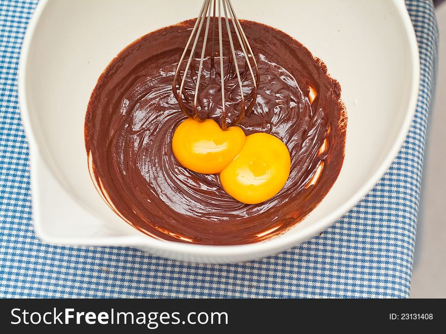 Mixing egg yolks with chocolate for dessert. Mixing egg yolks with chocolate for dessert.