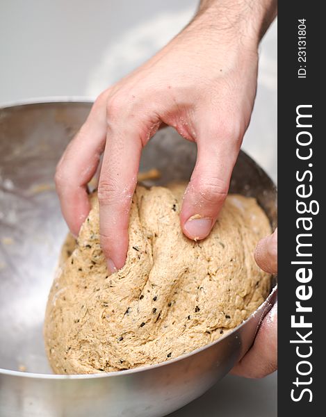 Chef rolling a sweet dark dough for a sweet bread. Chef rolling a sweet dark dough for a sweet bread.