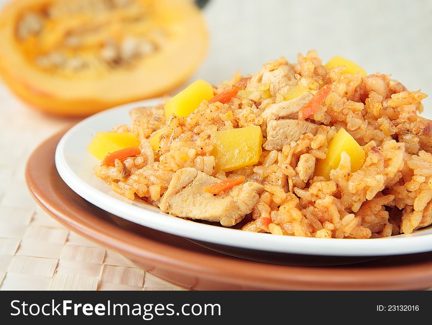 Pilaf with chunks of chicken, carrots and pumpkin. Pilaf with chunks of chicken, carrots and pumpkin