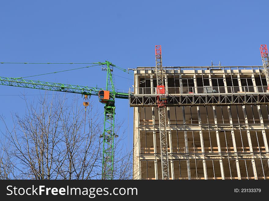 A construction crane with a building