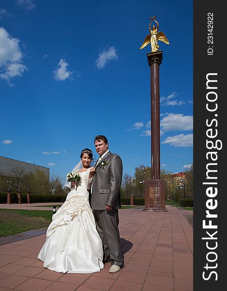 Bride And Groom On The Background Of The Monument