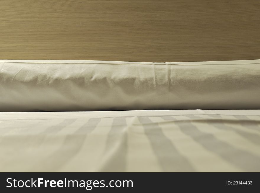 Fragment of clean fresh laid bed; selective focus on pillow. Fragment of clean fresh laid bed; selective focus on pillow