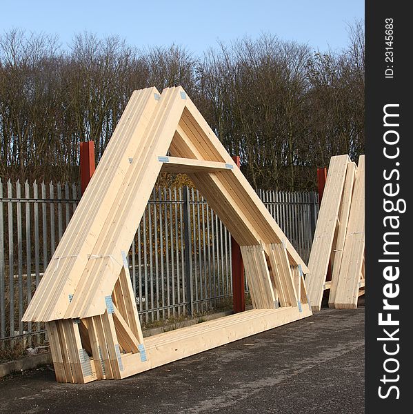 A Stack of Timber Roof Trusses in a Stock Yard.
