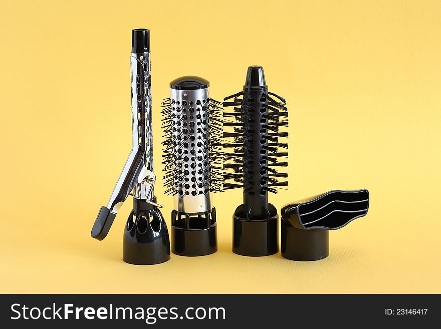 Hairdressing set with various accessories on yellow background