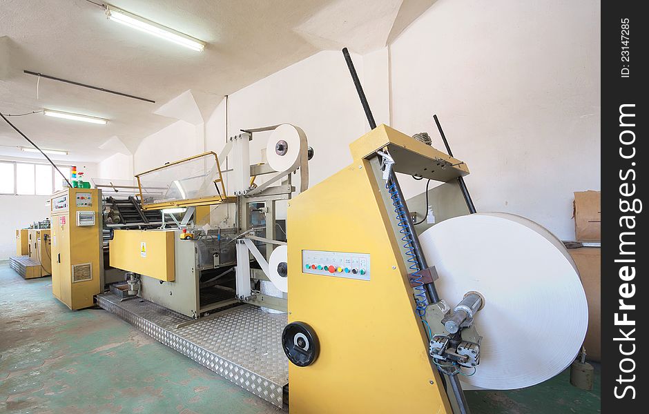 Interior of a factory, old machine for printing. Interior of a factory, old machine for printing.