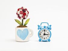 Blue Alarm Clock With Cup Of Rose Flower Stock Photo Blue Alarm Clock With Cup Of Rose Flower Stock Photo