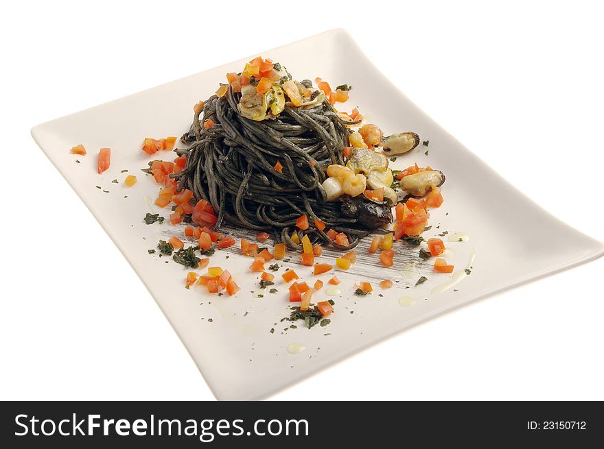 Squid ink spaghetti on white plate