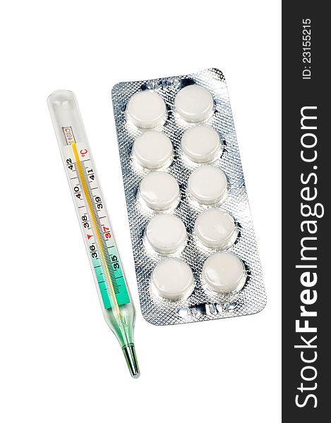 The medical thermometer and tablets on a white background