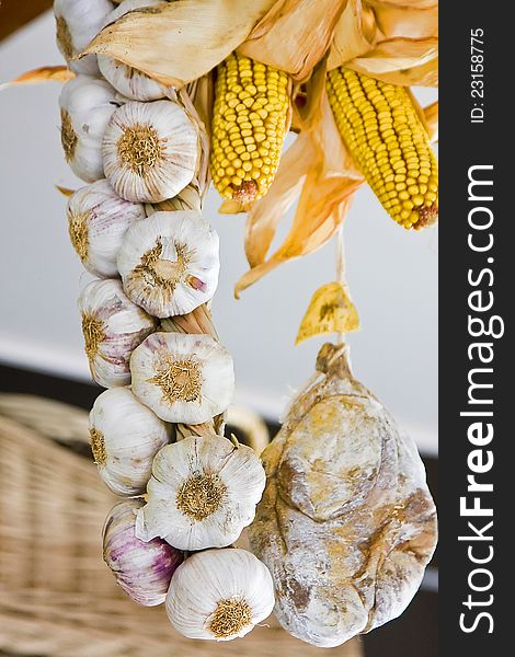 Bundle of garilc, corn, and salted meat hanging from the ceiling.