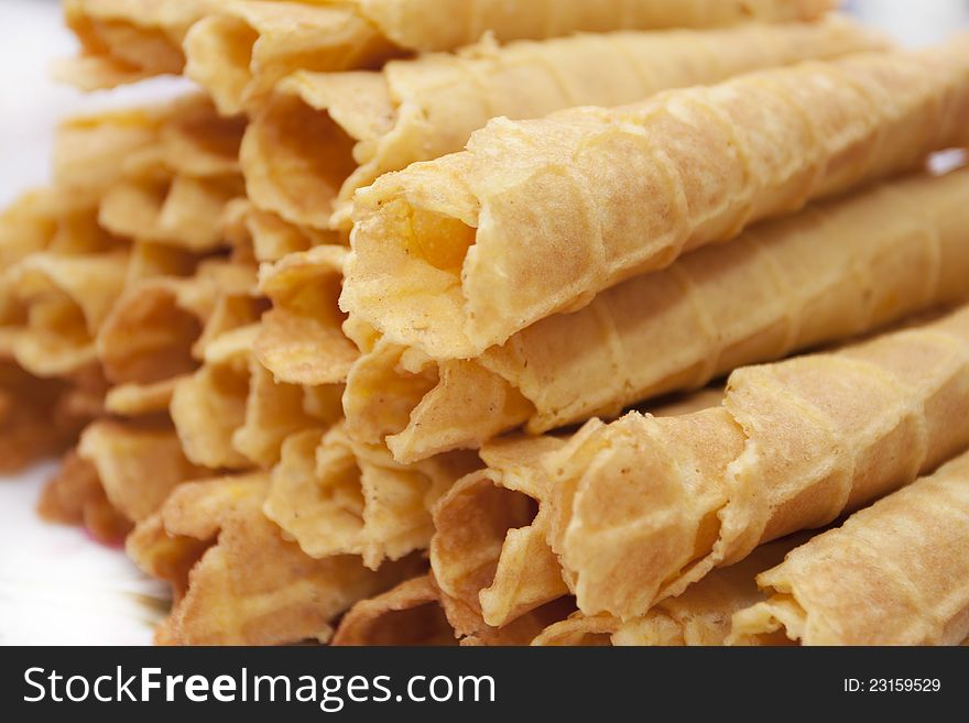 Dessert - sweet yellow wafers on desktop in a plate