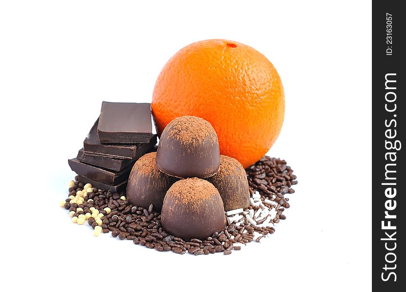 Chocolate candy, chocolate and orange on a white b