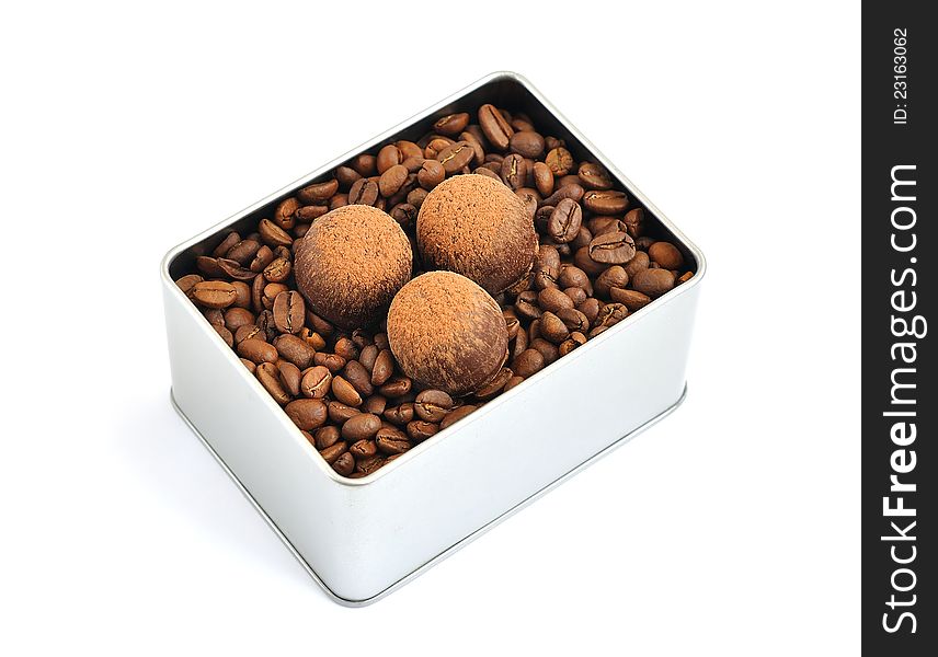 Chocolates, coffee beans in a tin box on a white background