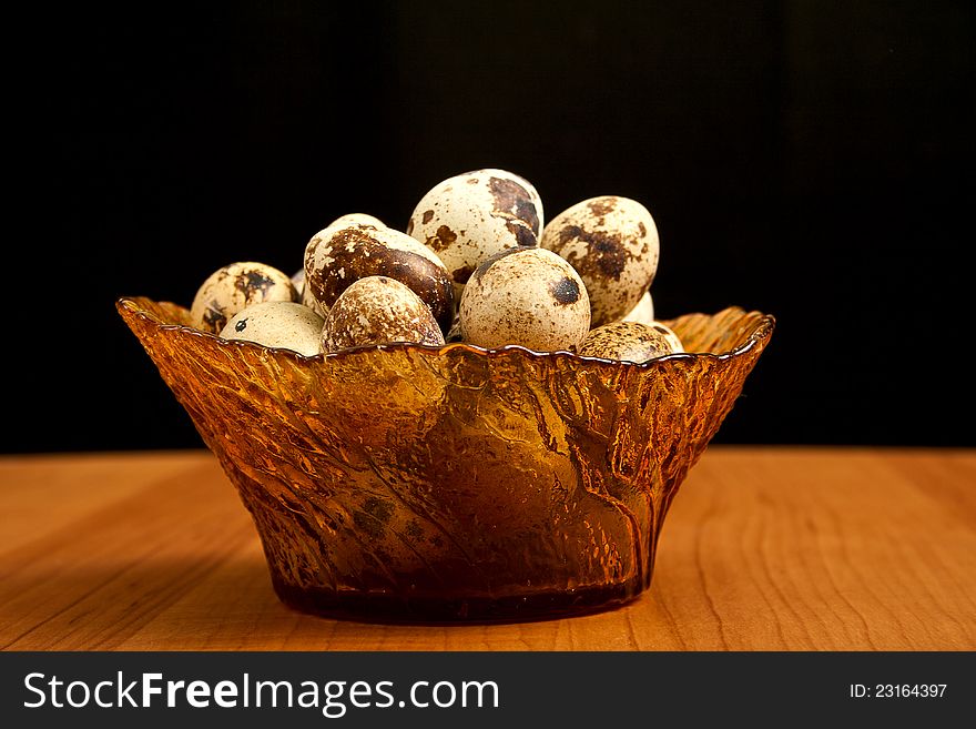 Vase with quail eggs on wooden table. Vase with quail eggs on wooden table.