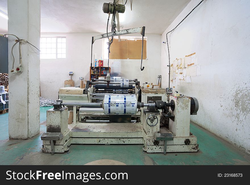 Interior of a factory, old machine for printing. Interior of a factory, old machine for printing.