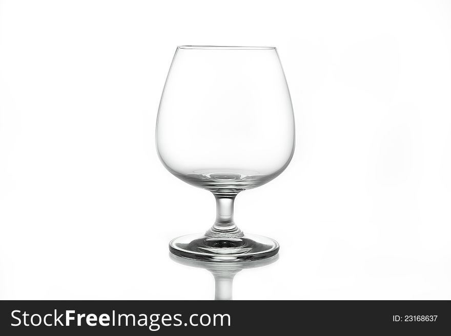 Empty brandy glass on white background