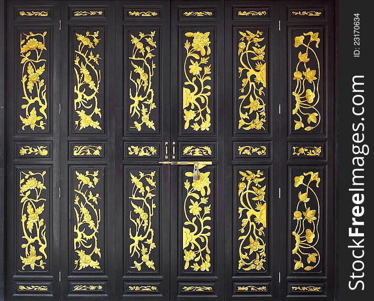 Flower carved gold paint on vintage wood door. Flower carved gold paint on vintage wood door