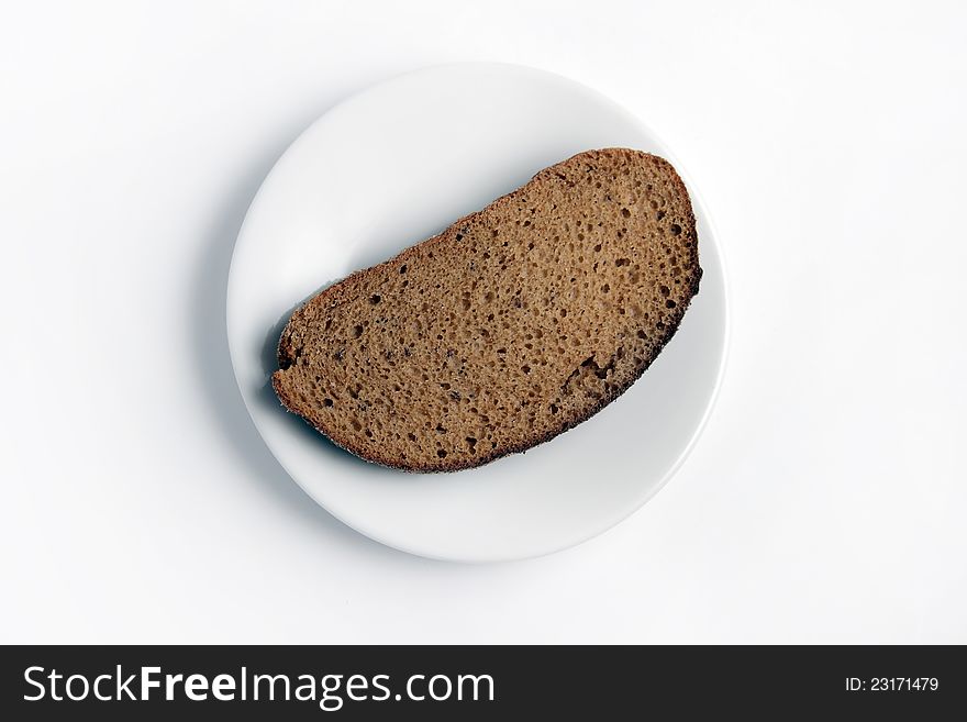 Slice of bread on a white plate on a white background