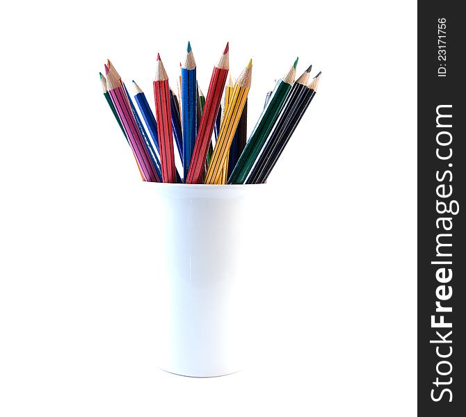 High-key, back lit image of colored crayon pencils in a white container. Copy space. High-key, back lit image of colored crayon pencils in a white container. Copy space.