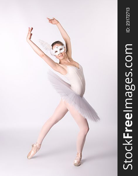 Ballerina in a white skirt and a bathing suit, pointe, dance poses
