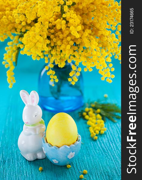 Easter decoration with yellow mimosa and egg