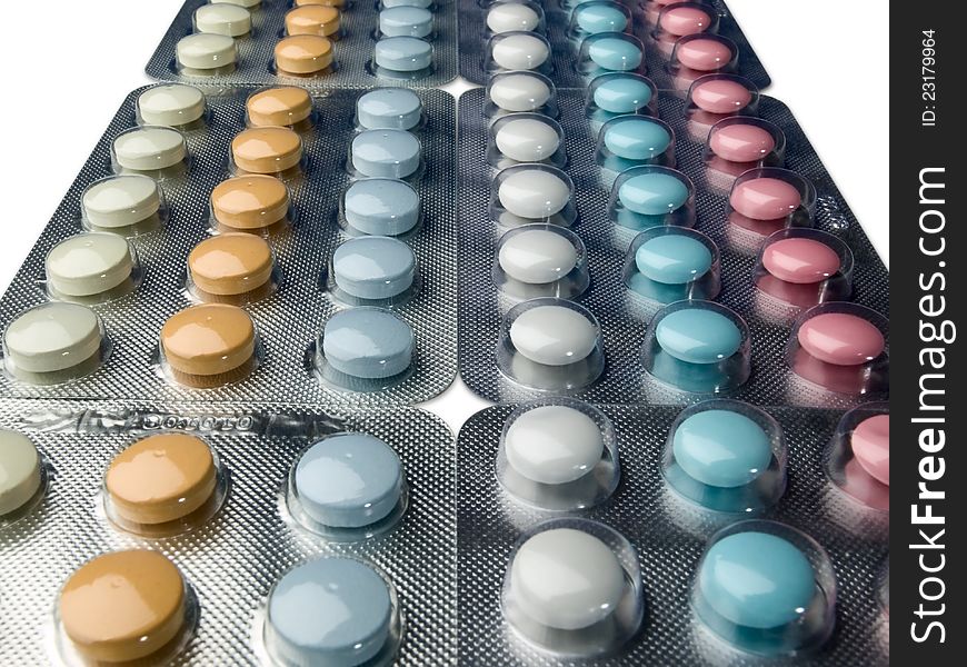 Multi-coloured tablets in plastic packing. Multi-coloured tablets in plastic packing.