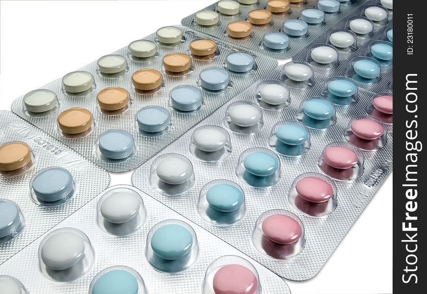 Multi-coloured tablets in plastic packing. Multi-coloured tablets in plastic packing.