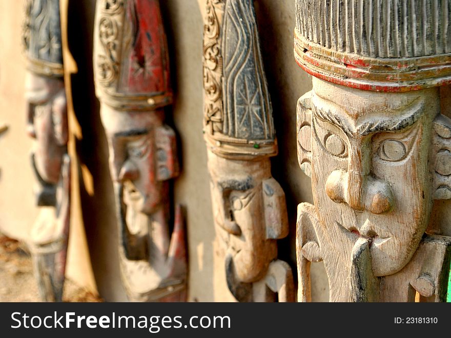 Four wooden mask hang on the wall