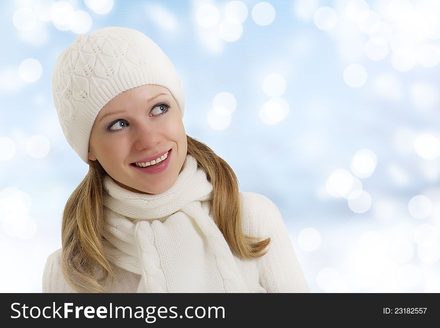 Beautiful happy young woman in a winter hat and scarf outdoors. Beautiful happy young woman in a winter hat and scarf outdoors