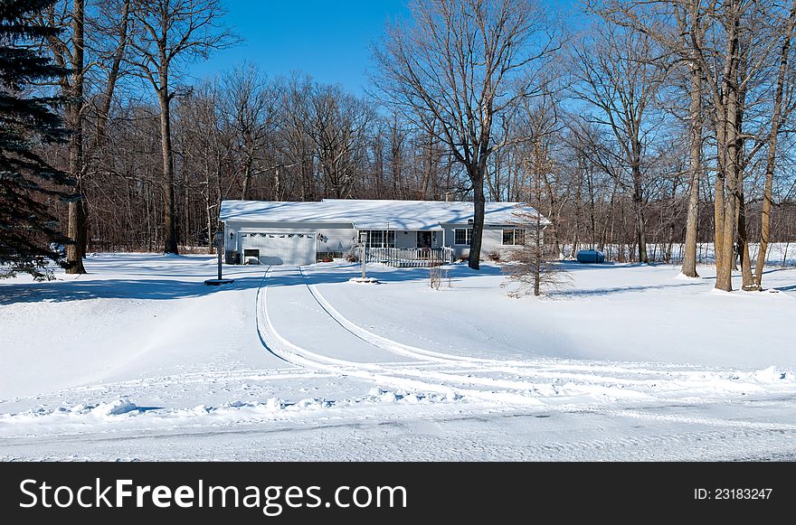 A small family home covered by snow. A small family home covered by snow.