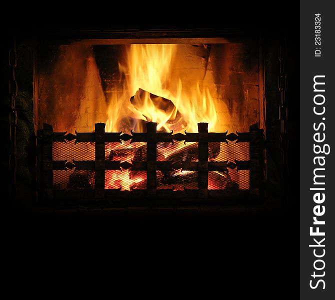 Fireplace with a blazing fire. Background for design. Fireplace with a blazing fire. Background for design