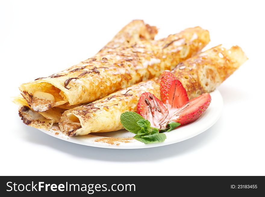 Pancakes with strawberry and glaze and leaflets of mint