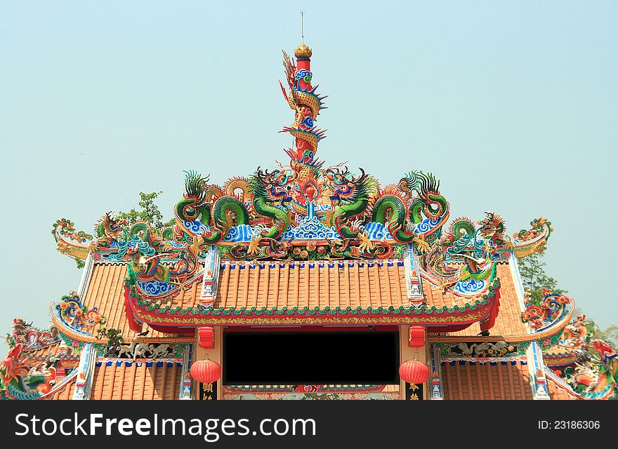 Dragon Statue on Top of Chinese Temple Shrine with blue sky