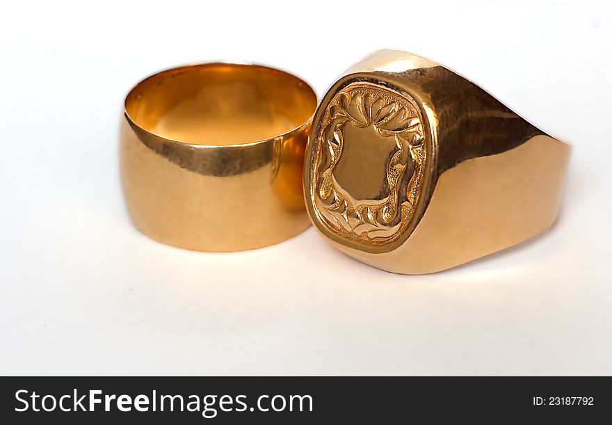 Two bright golden rings  on white background. Two bright golden rings  on white background