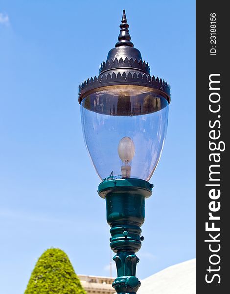 Retro lamppost against blue sky