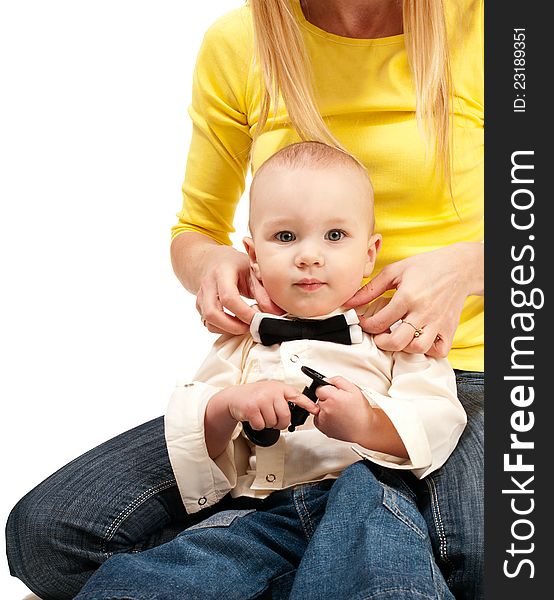 Mom adjusting bow tie for her baby isolated on white