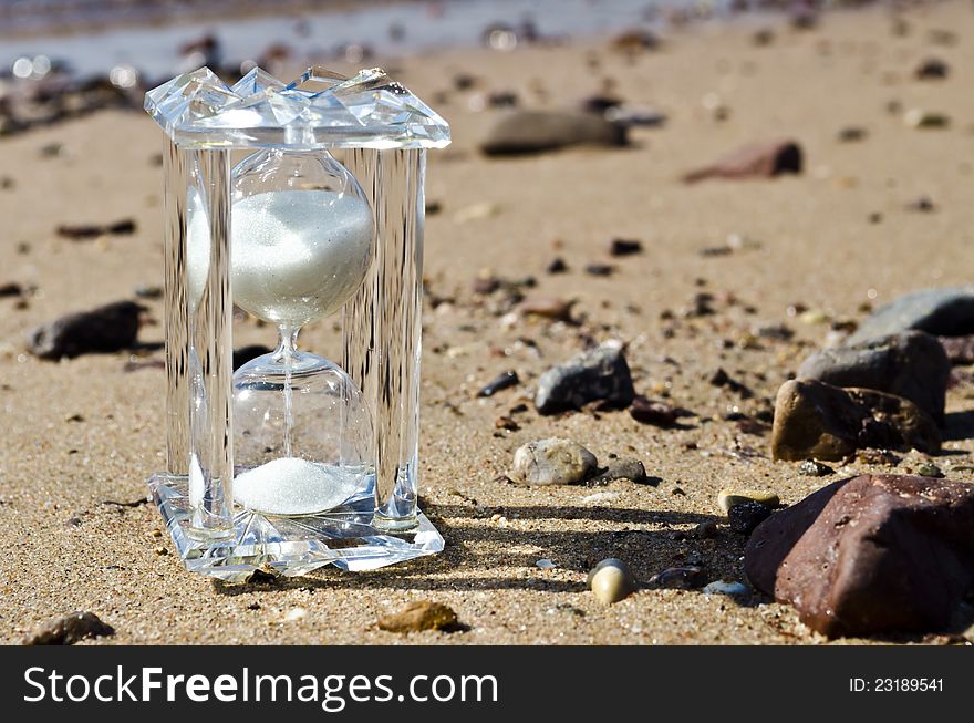 Crystal Hourglass On Marine Beach