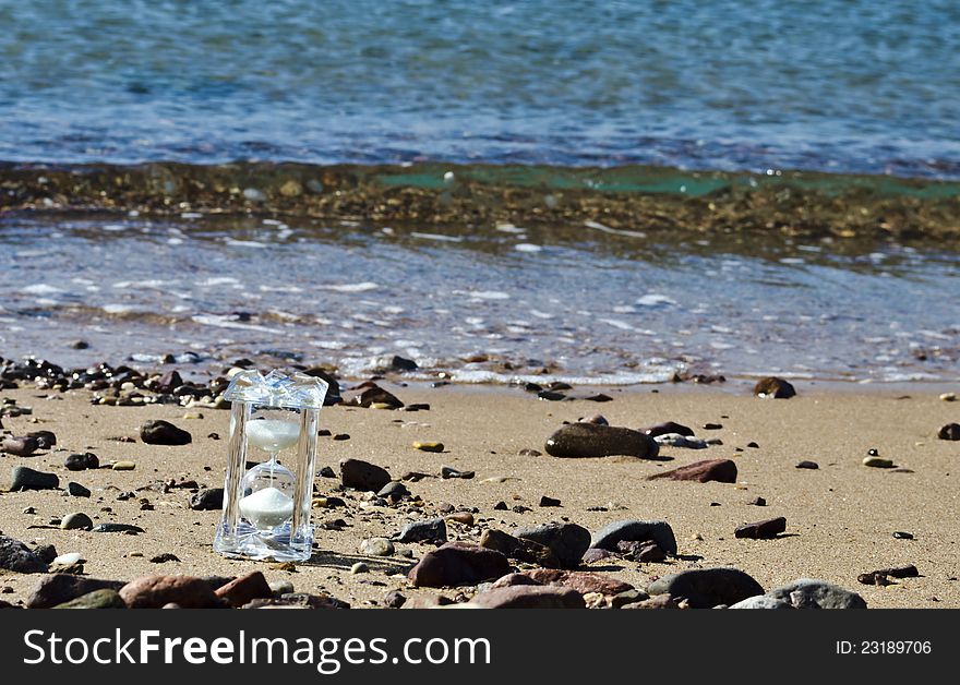 Crystal hourglass on marine beach