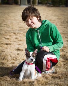 Boy With Cattle Dog / Boxer Hybrid Puppy Royalty Free Stock Photography