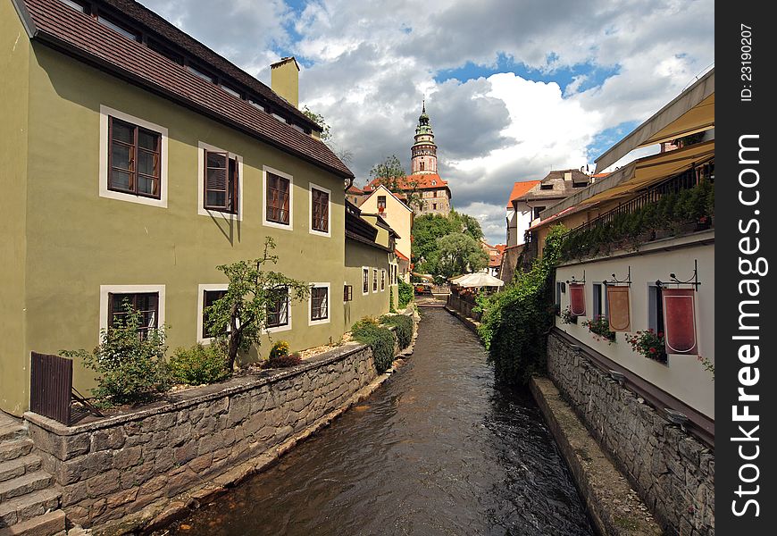 Narrow side canal at Cesky Krumlov. Cesky Krumlov is a small city in the South Bohemian Region of the Czech Republic, best known for the fine architecture and art of the historic old town.