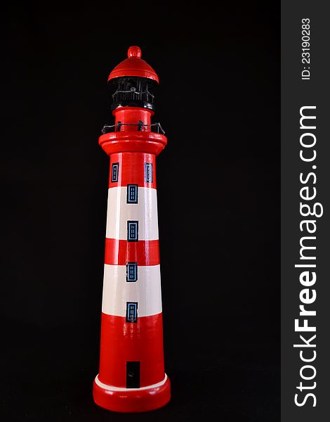 Decorative lighthouse red an white with black background