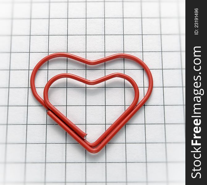 Closeup of heart shaped red paper clip. Closeup of heart shaped red paper clip