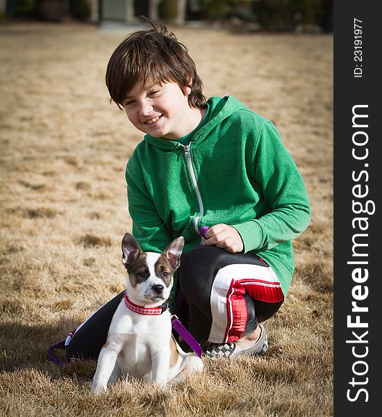 A boy poses with his hybrid canine mixed breed including cattle dog and boxer. A boy poses with his hybrid canine mixed breed including cattle dog and boxer.