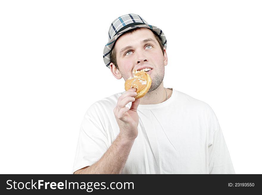 Man in a hat with a donut in his hand. Man in a hat with a donut in his hand