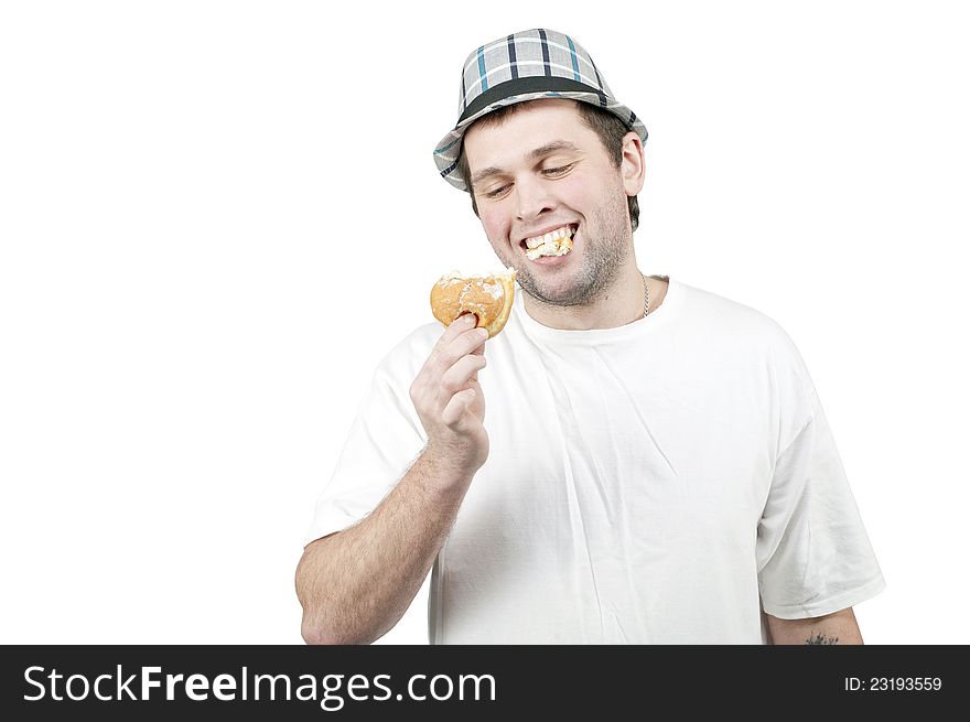 Man in a hat with a donut in his hand. Man in a hat with a donut in his hand