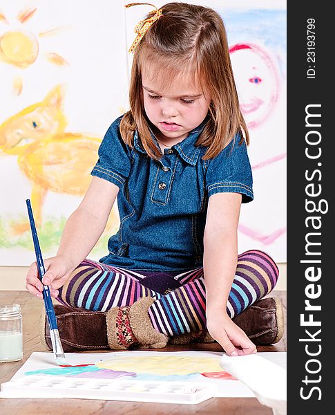 Little girl concentrating on painting a flower. Little girl concentrating on painting a flower