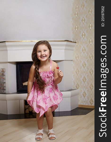 Smiling Girl In Pink Dress At Home With Sweet