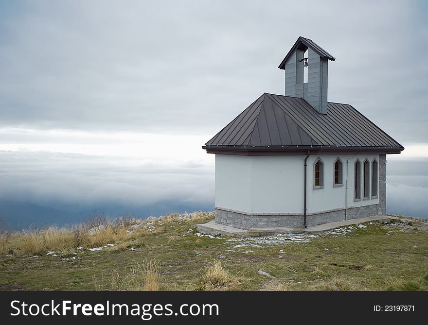 Matajur church on the top alps in the fogg