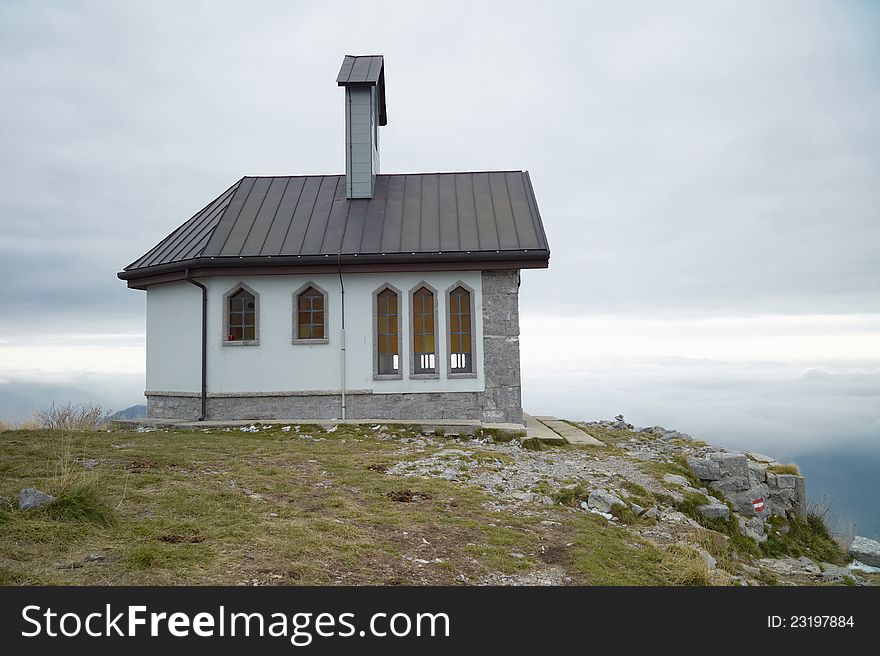 Matajur church on the top alps in the fogg